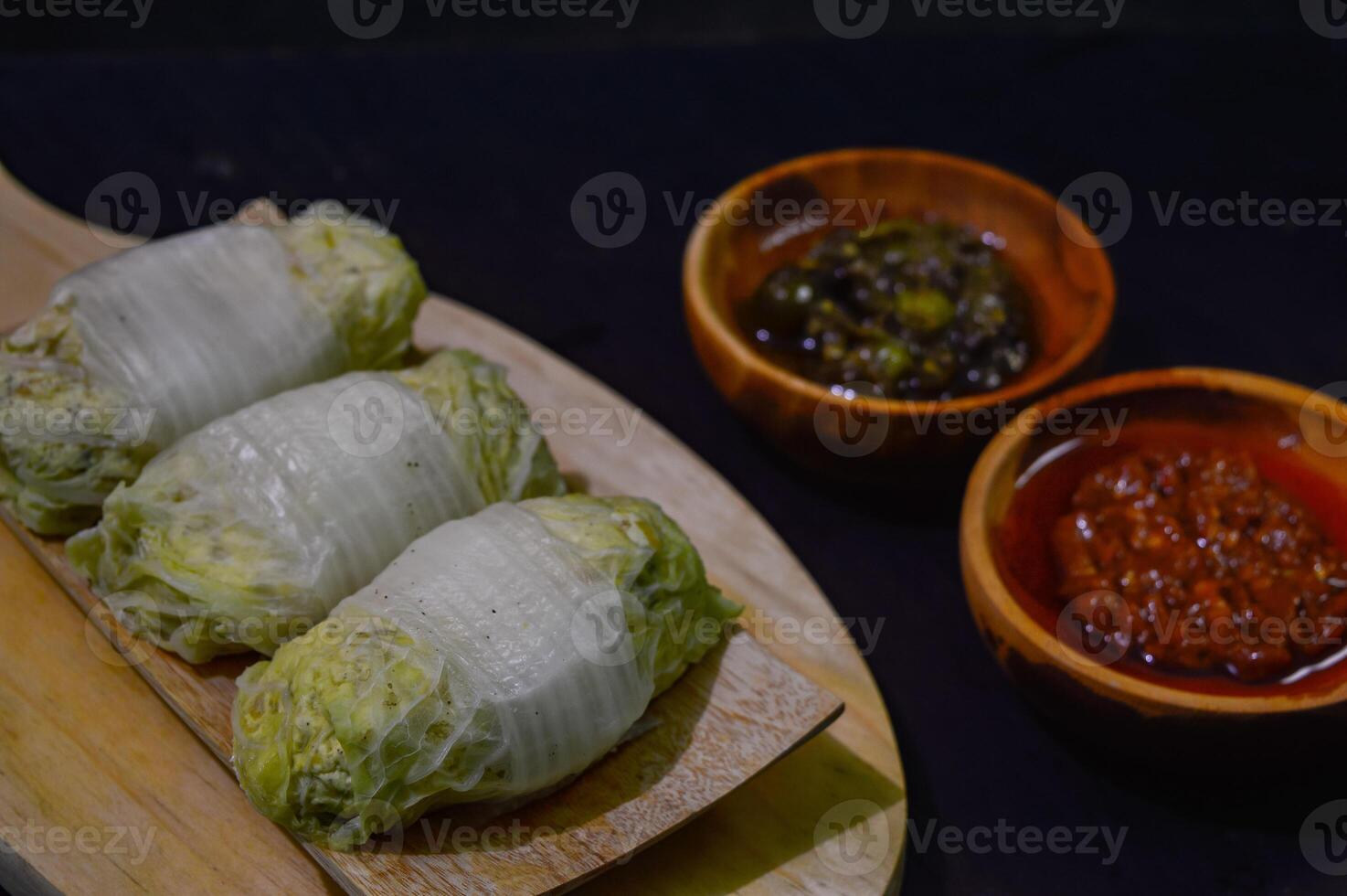 Sawi gulung tahu or rolled Chinese cabbage with tofu. Served with red chilli sauce and green chilli sauce. photo
