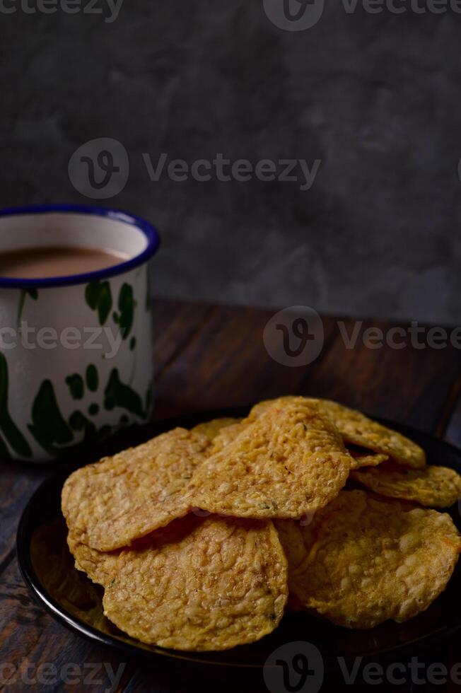 Tempeh chips are a food made from tempeh which is thinly sliced and then fried using seasoned flour. Usually the taste is salty with a savory onion aroma. photo