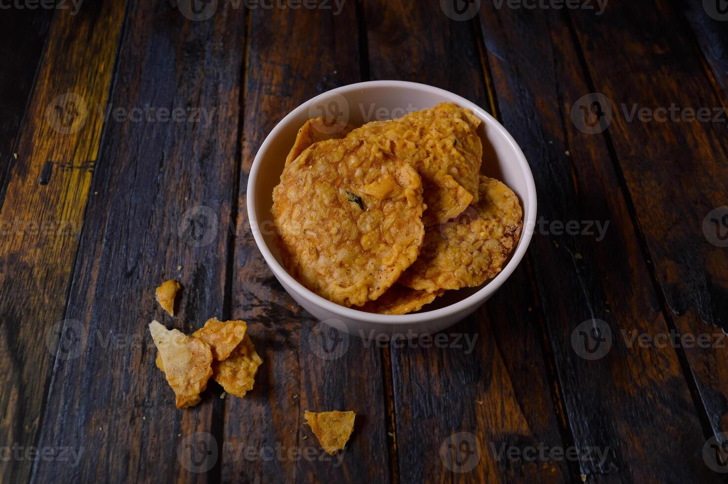 Tempeh chips are a food made from tempeh which is thinly sliced and then fried using seasoned flour. Usually the taste is salty with a savory onion aroma. photo