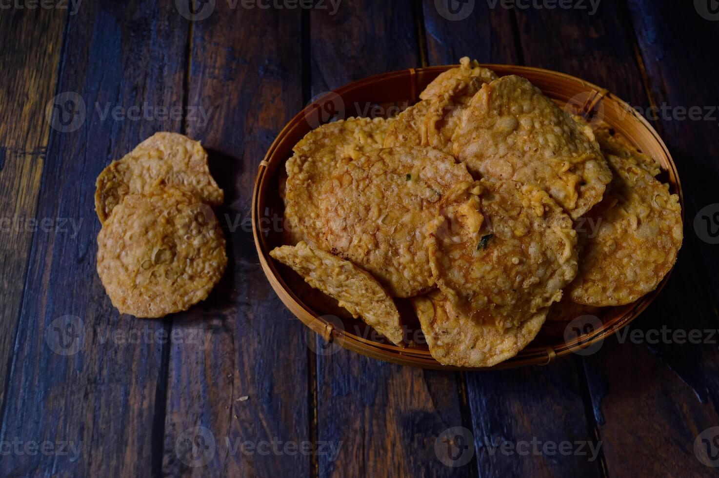 Tempeh chips are a food made from tempeh which is thinly sliced and then fried using seasoned flour. Usually the taste is salty with a savory onion aroma. photo
