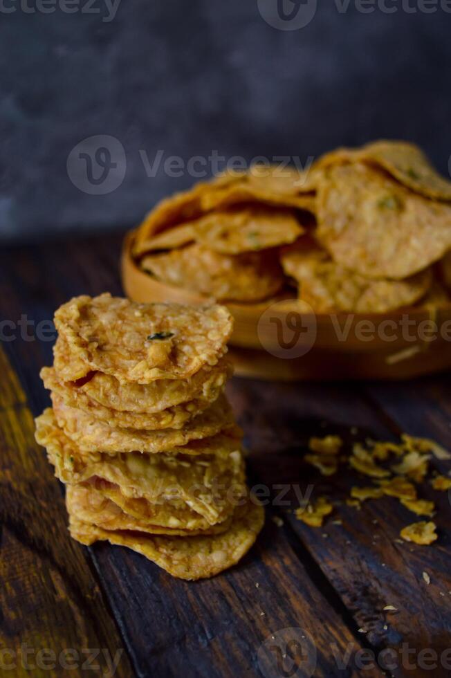 Tempeh chips are a food made from tempeh which is thinly sliced and then fried using seasoned flour. Usually the taste is salty with a savory onion aroma. photo