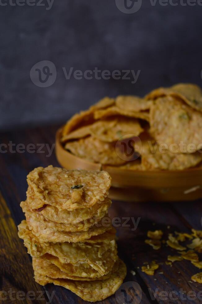 Tempeh chips are a food made from tempeh which is thinly sliced and then fried using seasoned flour. Usually the taste is salty with a savory onion aroma. photo