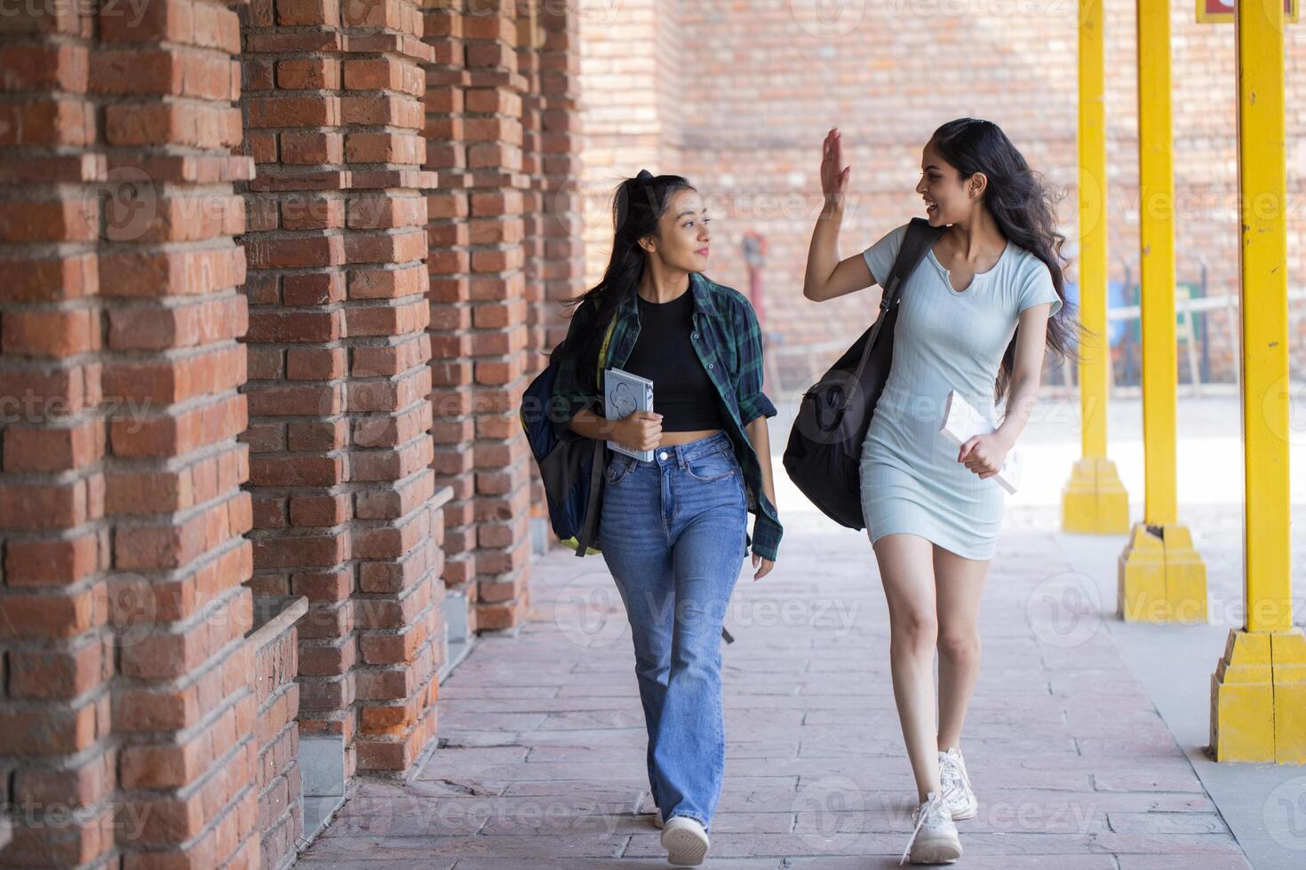 Gorgeous Friends Are Walking Together, and One of Them Raising His Hands in the Air photo