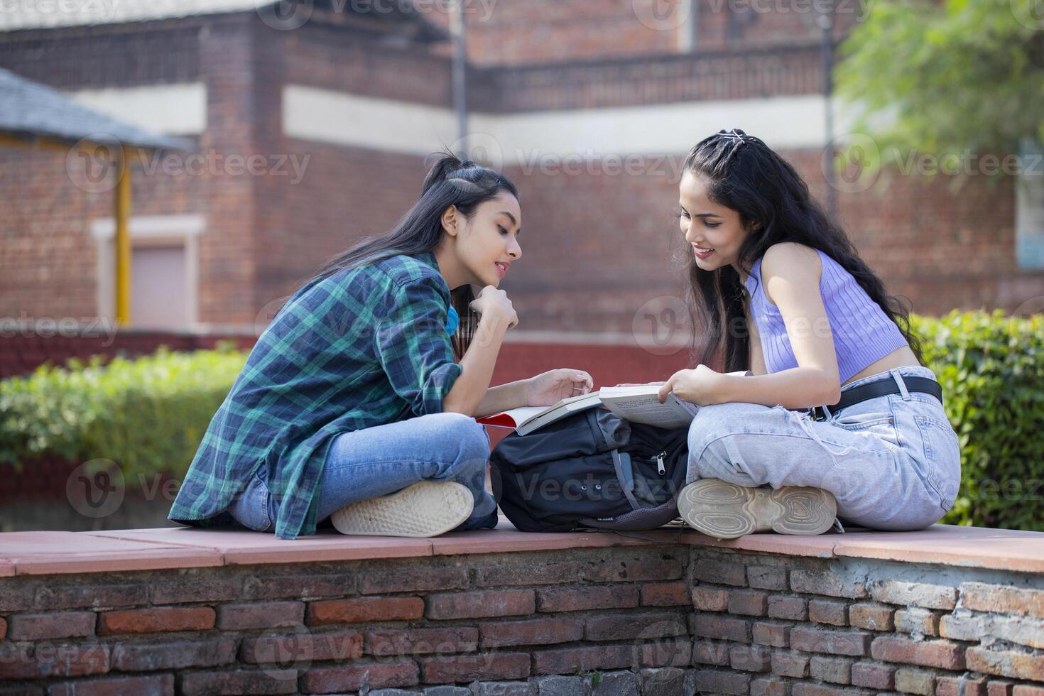 Two Educated Adults Solving the Questions While Holding Books photo
