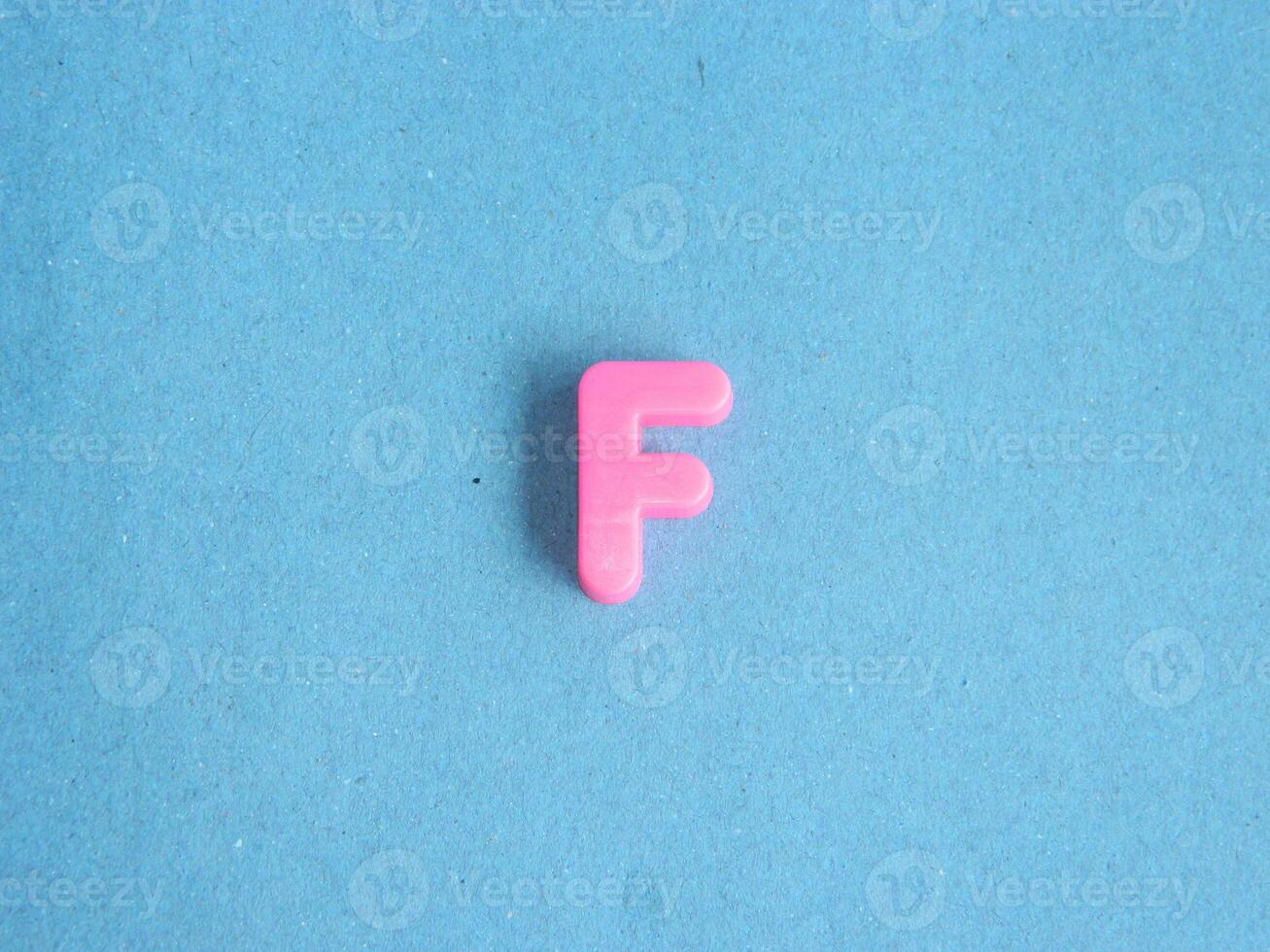 Macro photo or closeup photo of the alphabet from children's toys on a blue background. Use on preschool also
