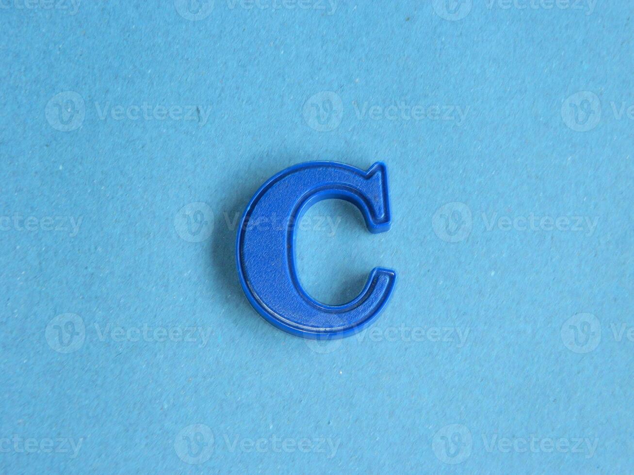 Macro photo or closeup photo of the alphabet from children's toys on a blue background. Use on preschool also