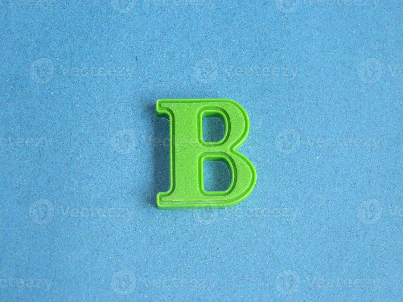 Macro photo or closeup photo of the alphabet from children's toys on a blue background. Use on preschool also