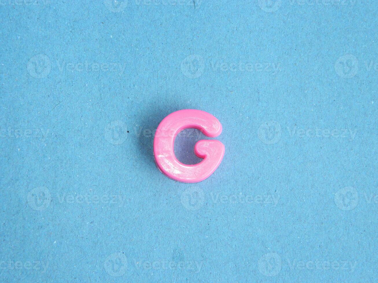 Macro photo or closeup photo of the alphabet from children's toys on a blue background. Use on preschool also