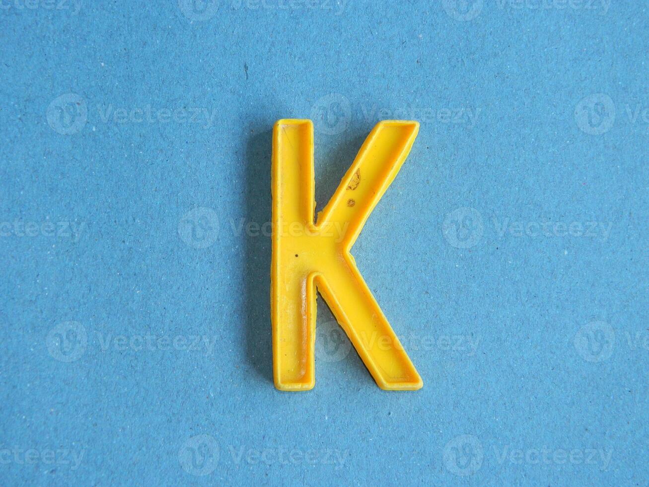 Macro photo or closeup photo of the alphabet from children's toys on a blue background. Use on preschool also