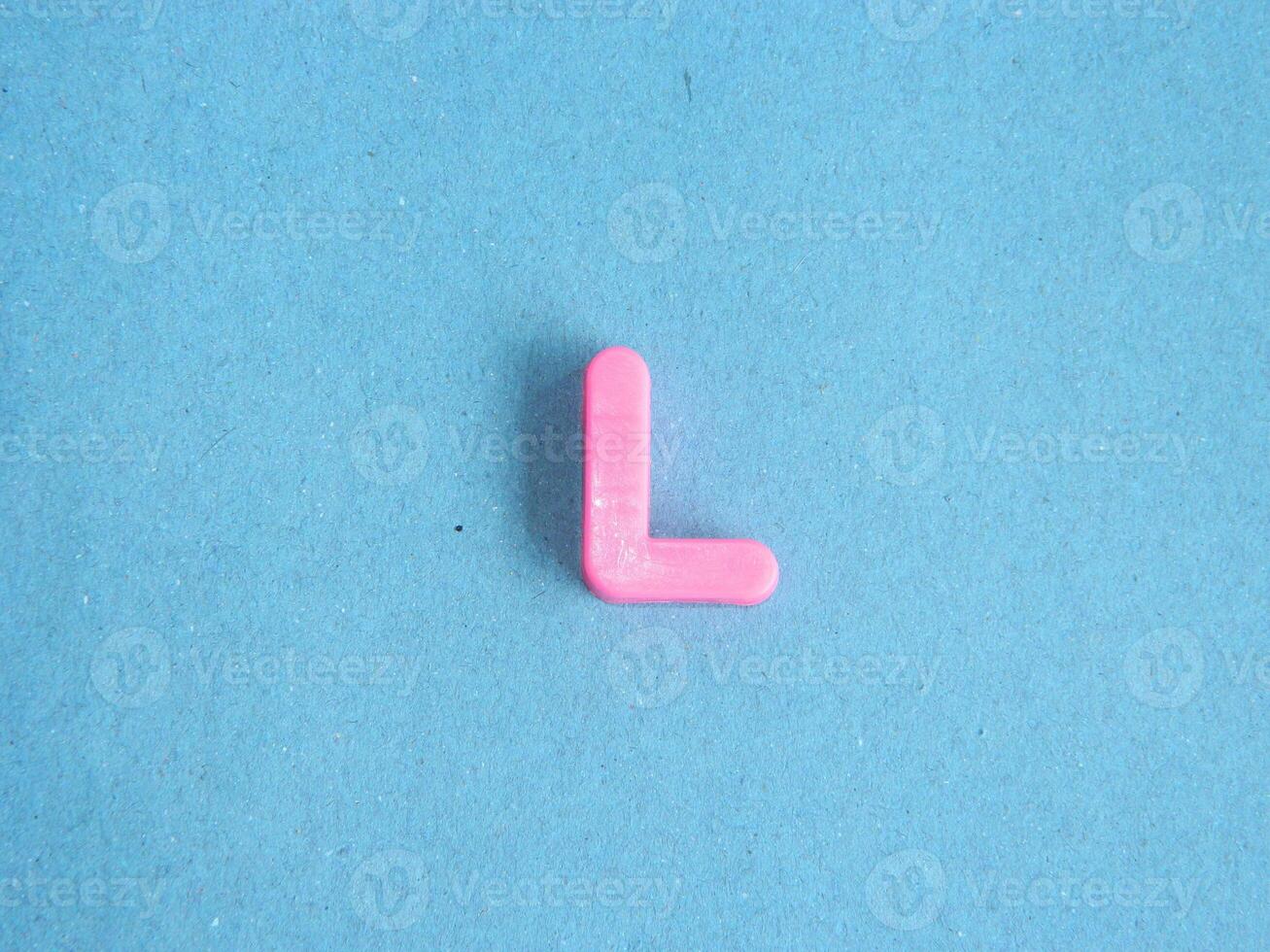 Macro photo or closeup photo of the alphabet from children's toys on a blue background. Use on preschool also
