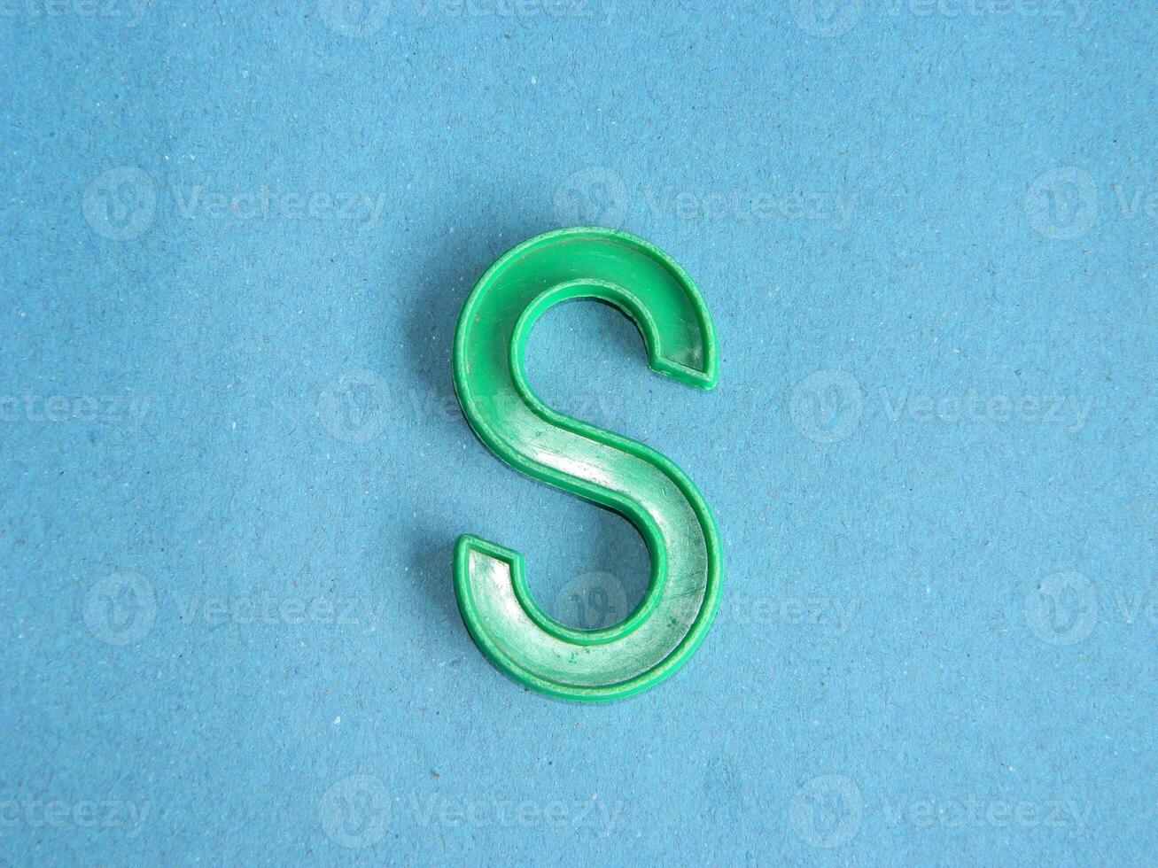 Macro photo or closeup photo of the alphabet from children's toys on a blue background. Use on preschool also