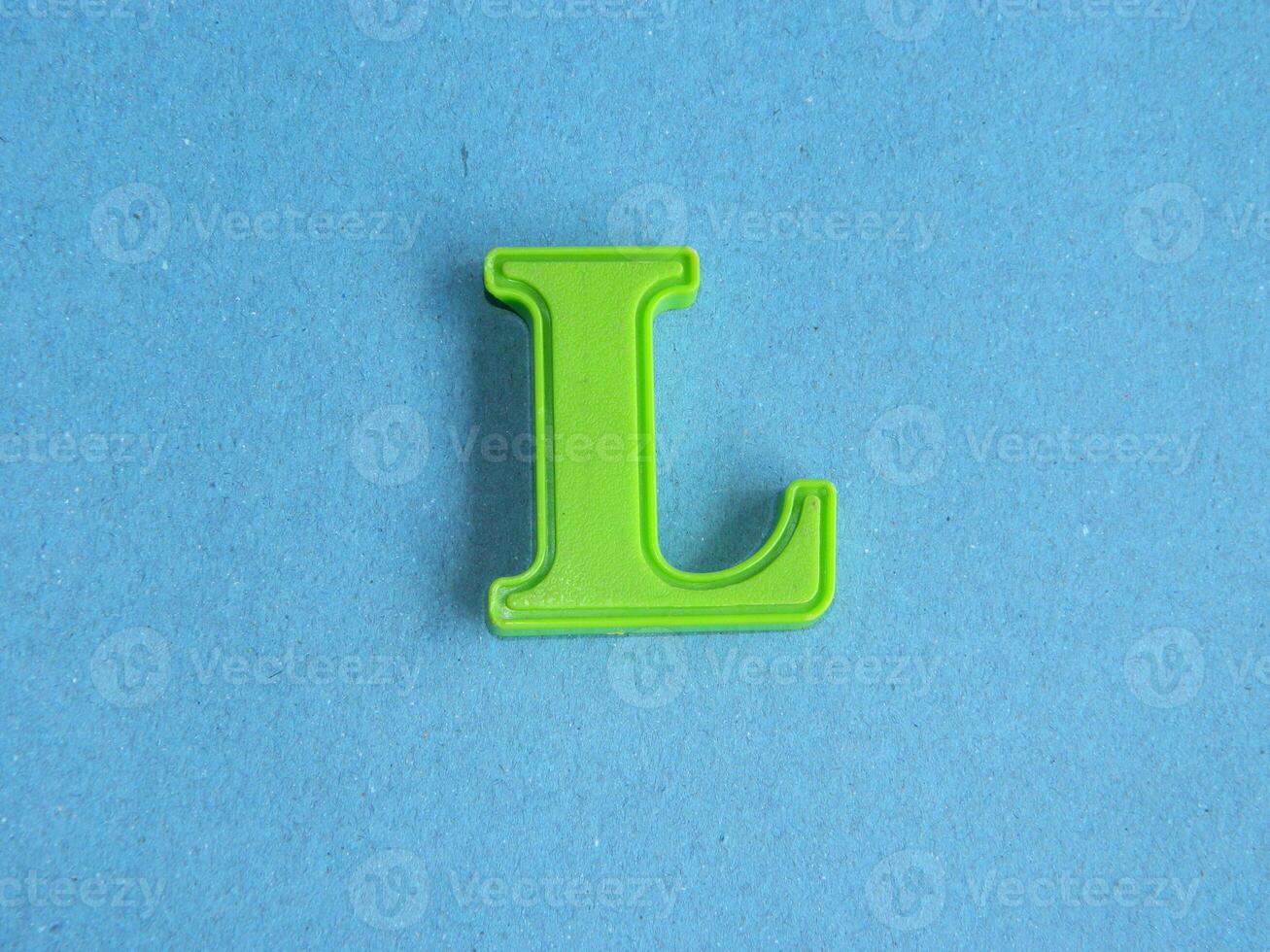Macro photo or closeup photo of the alphabet from children's toys on a blue background. Use on preschool also