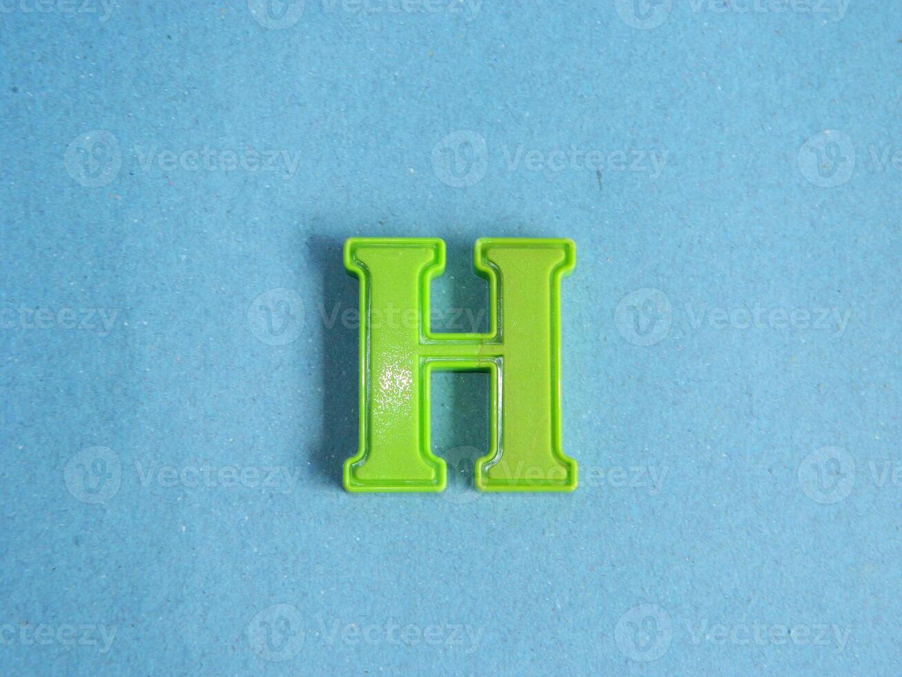 Macro photo or closeup photo of the alphabet from children's toys on a blue background. Use on preschool also