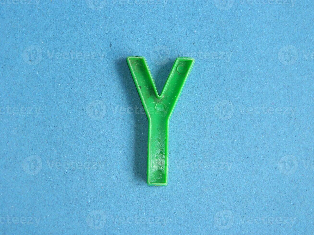 Macro photo or closeup photo of the alphabet from children's toys on a blue background. Use on preschool also