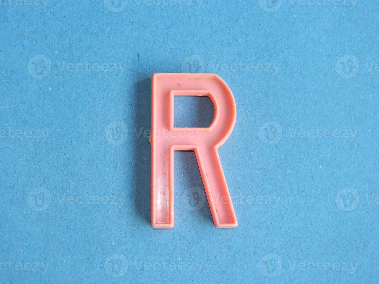 Macro photo or closeup photo of the alphabet from children's toys on a blue background. Use on preschool also