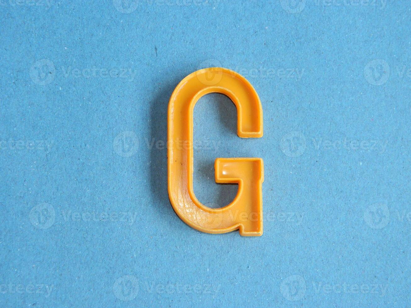Macro photo or closeup photo of the alphabet from children's toys on a blue background. Use on preschool also