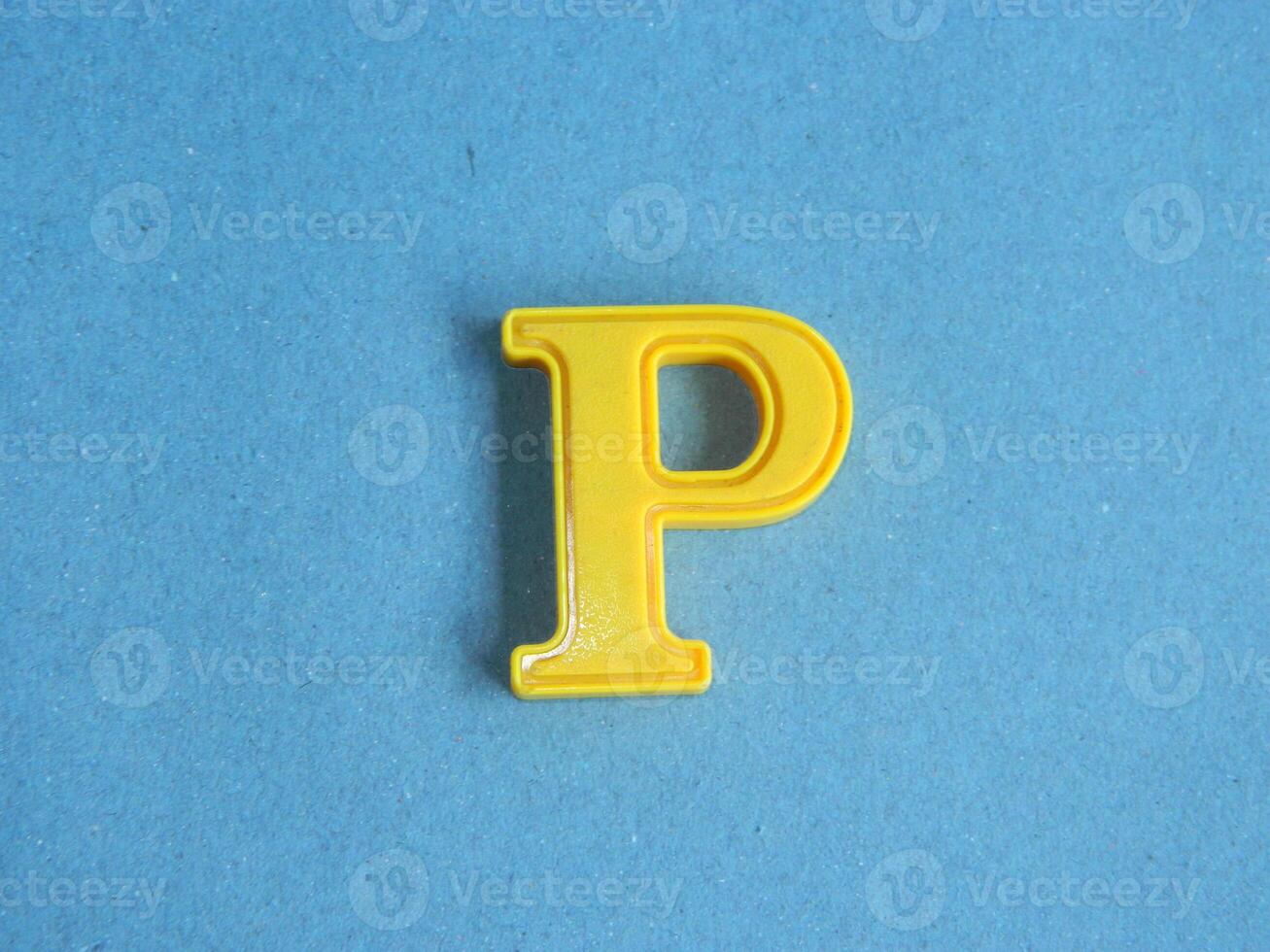 Macro photo or closeup photo of the alphabet from children's toys on a blue background. Use on preschool also