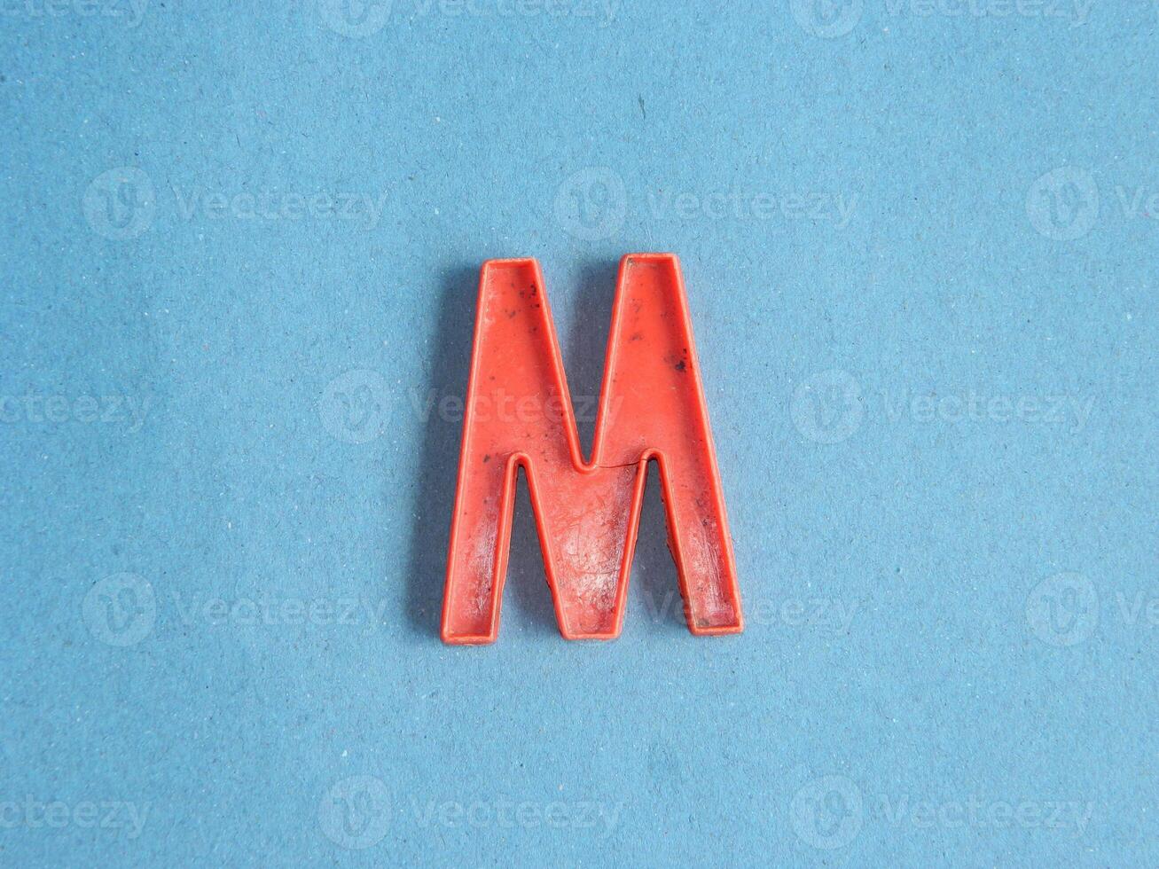 Macro photo or closeup photo of the alphabet from children's toys on a blue background. Use on preschool also