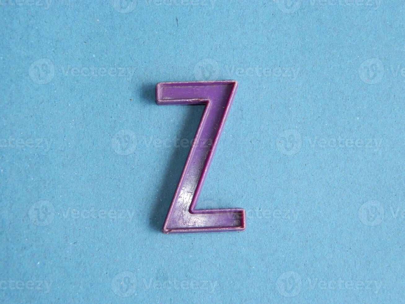 Macro photo or closeup photo of the alphabet from children's toys on a blue background. Use on preschool also