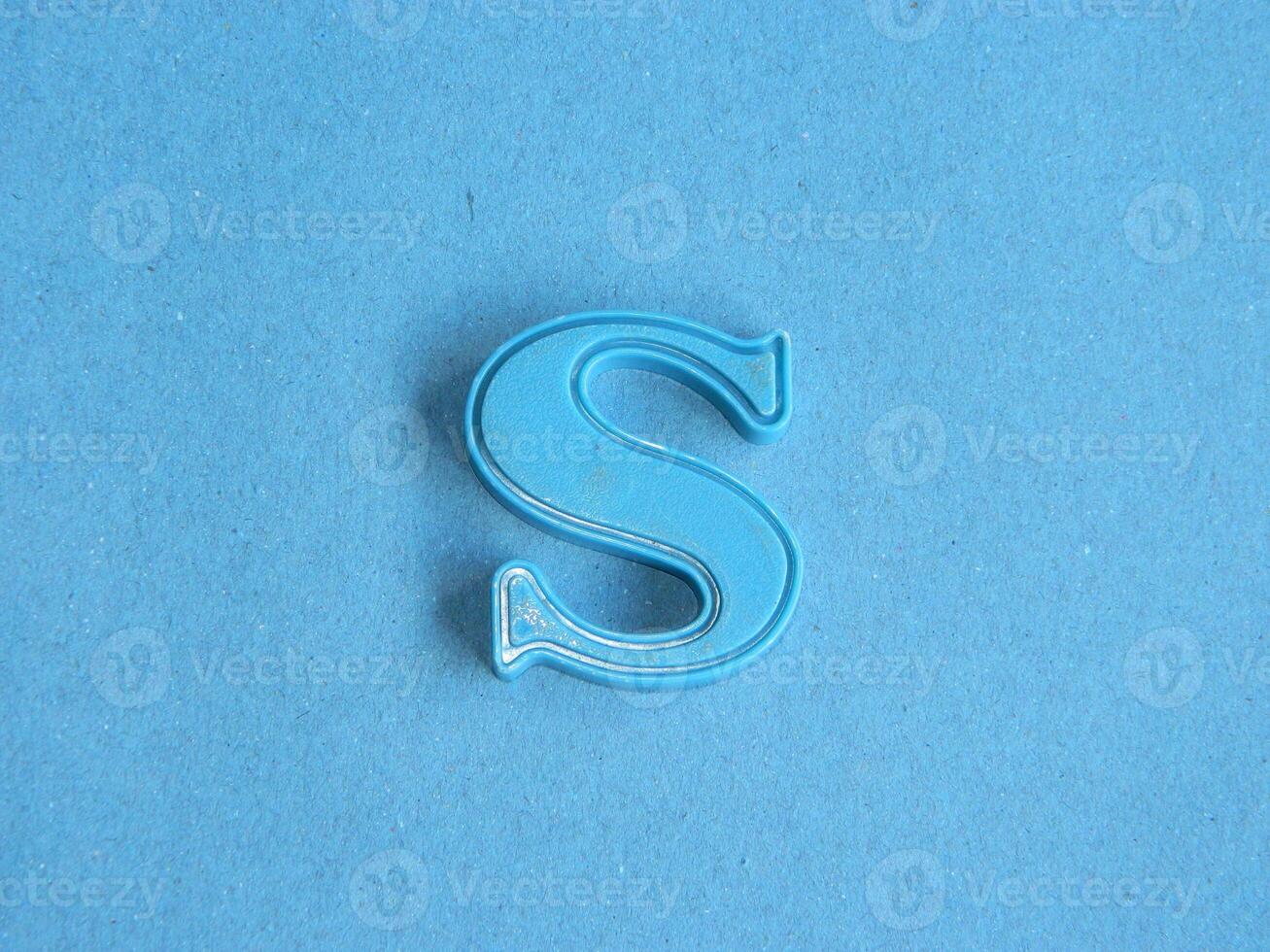 Macro photo or closeup photo of the alphabet from children's toys on a blue background. Use on preschool also