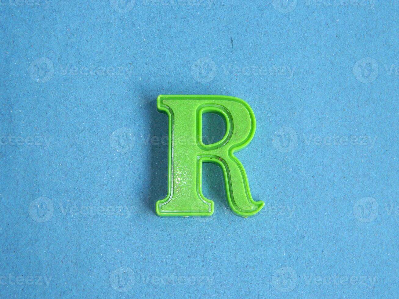 Macro photo or closeup photo of the alphabet from children's toys on a blue background. Use on preschool also