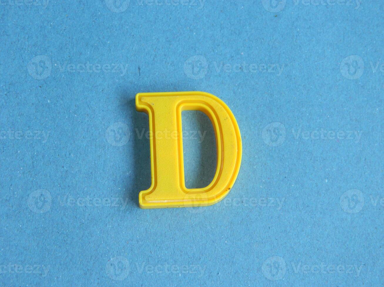 Macro photo or closeup photo of the alphabet from children's toys on a blue background. Use on preschool also