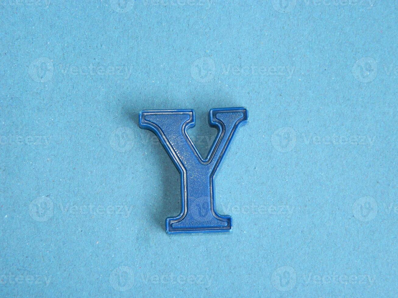 Macro photo or closeup photo of the alphabet from children's toys on a blue background. Use on preschool also