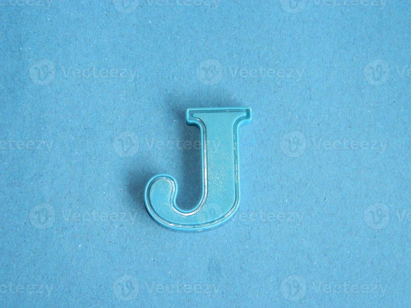 Macro photo or closeup photo of the alphabet from children's toys on a blue background. Use on preschool also