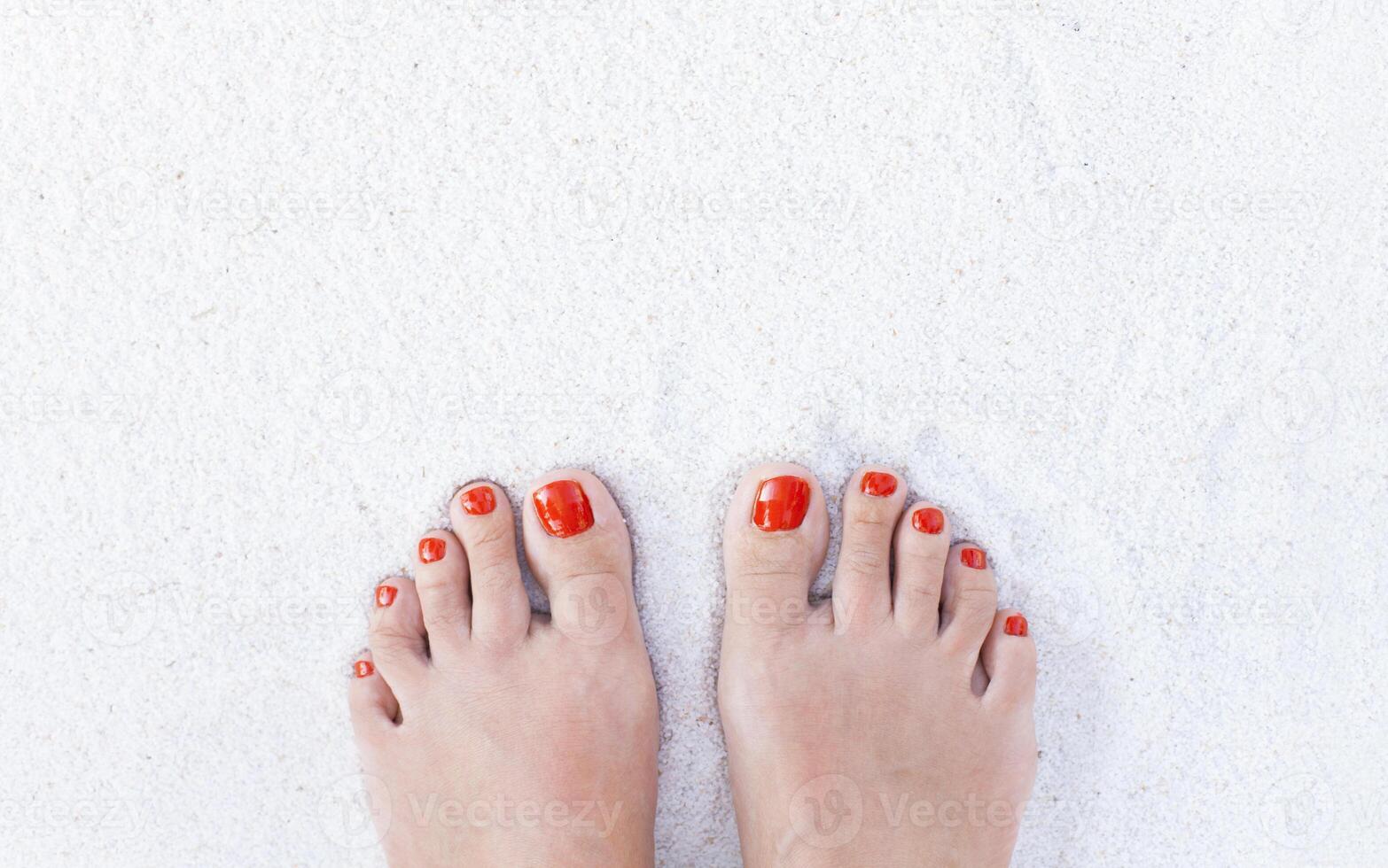 Female feet on sand photo