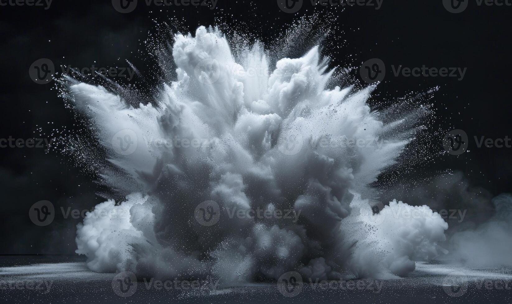 Powder explosion creating a white cloud on black background photo
