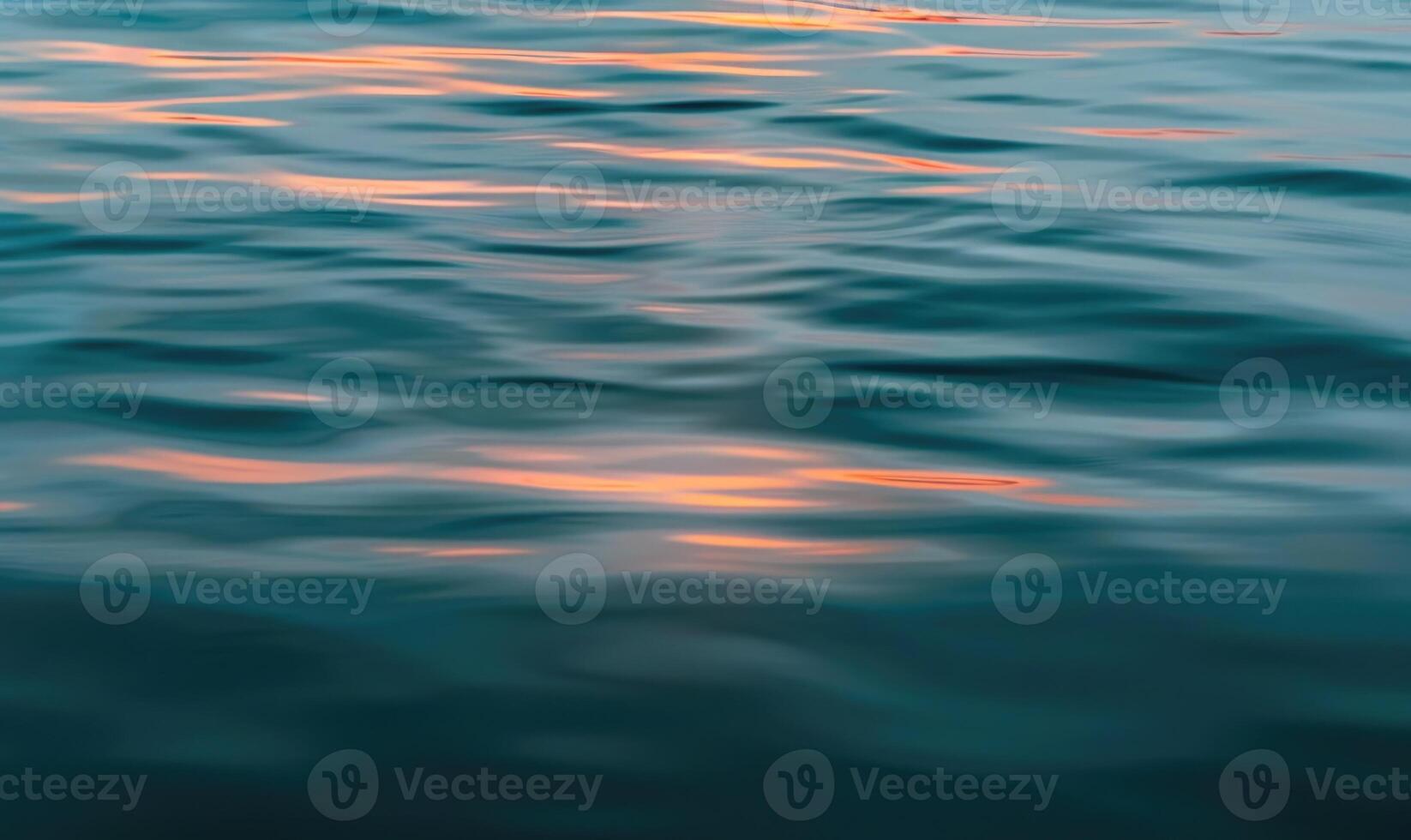 Closeup view on water surface with sunset light on it photo