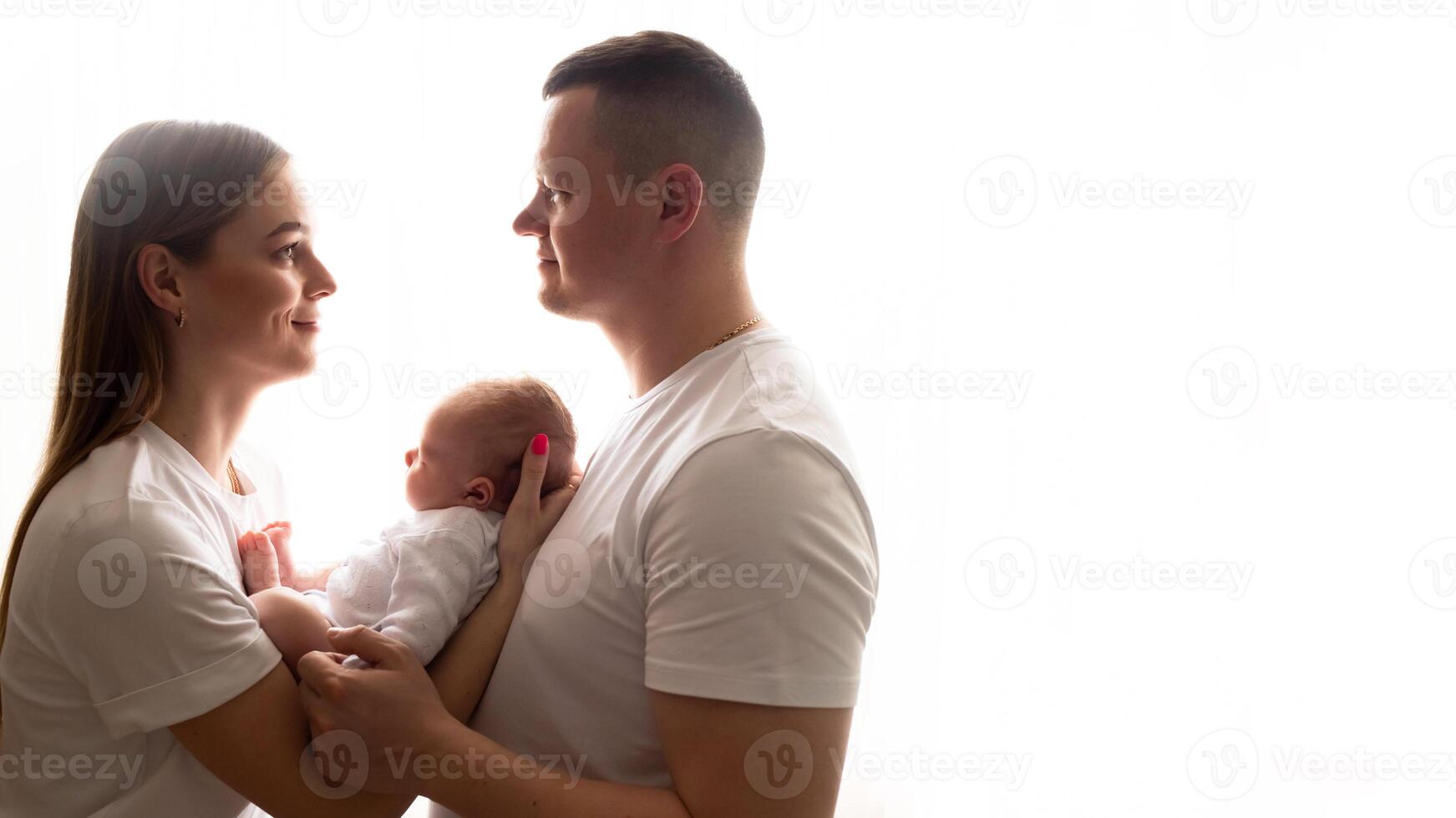 young parents hold the baby in their arms. family lifestyle photo with baby. family concept. family photo on white background