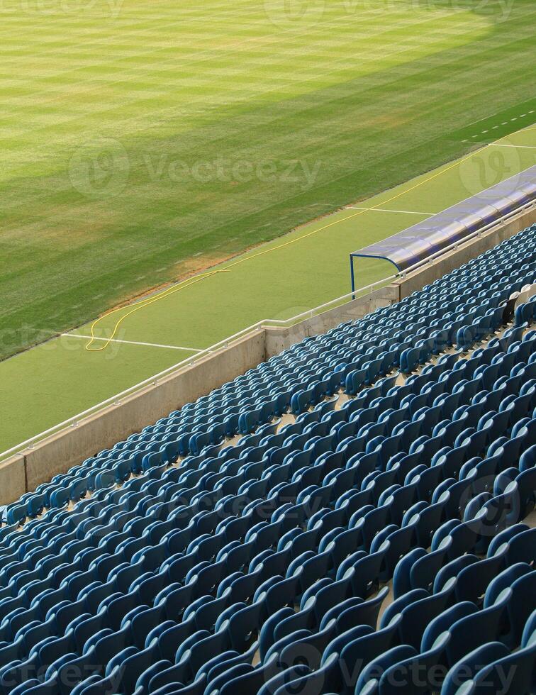 Empty Plastic Chairs In The Stands Of Football Stadium photo