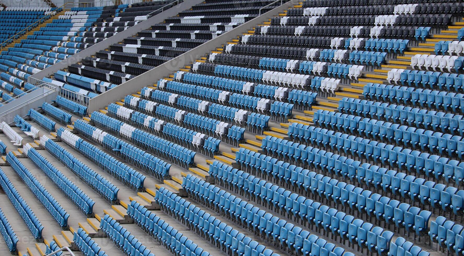 Lines Of Empty Plastic Spectators Chairs In A Grandstands photo