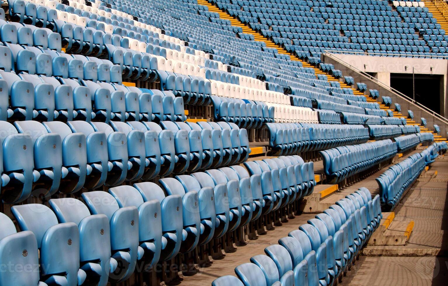Empty Rows Of Plastic Chairs Seats For Sport Fans On A Stadium photo