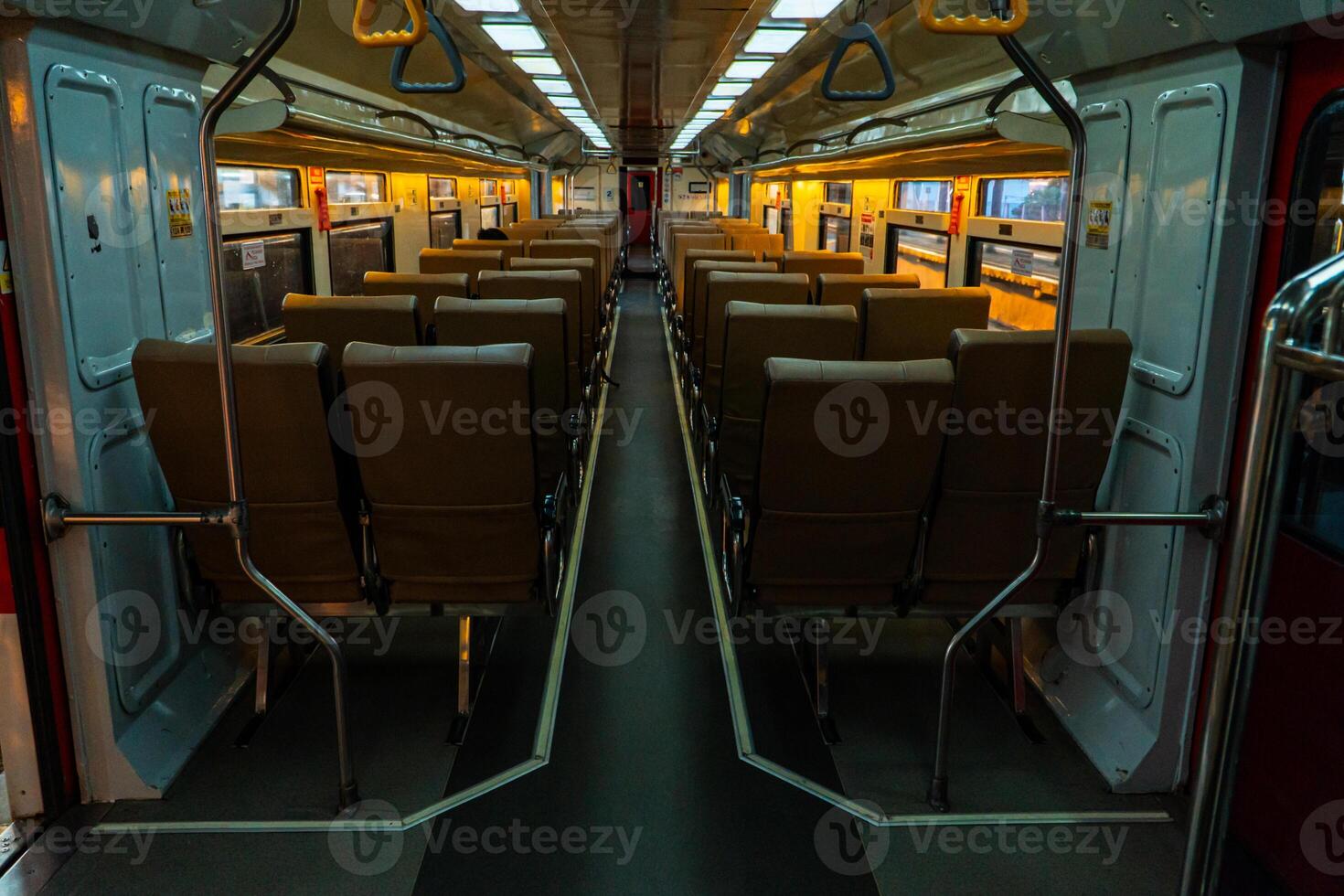 Public trains in Java, Indonesia are empty of passengers in the afternoon when the sun sets. The train carriage was quiet and many passenger seats were empty photo