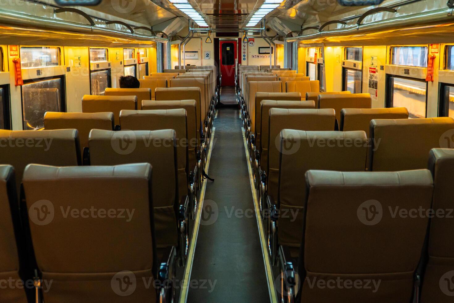 Public trains in Java, Indonesia are empty of passengers in the afternoon when the sun sets. The train carriage was quiet and many passenger seats were empty photo