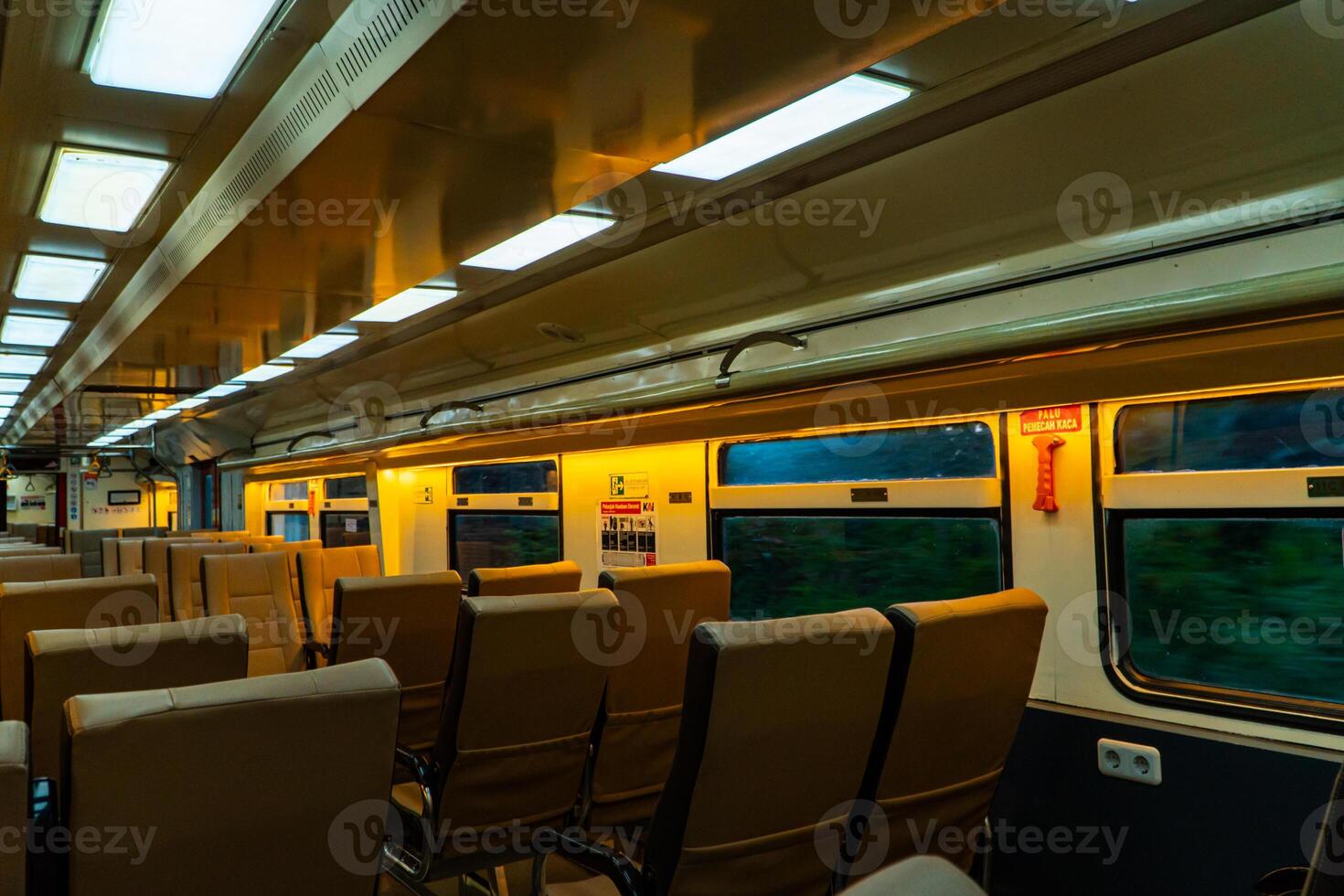 Public trains in Java, Indonesia are empty of passengers in the afternoon when the sun sets. The train carriage was quiet and many passenger seats were empty photo