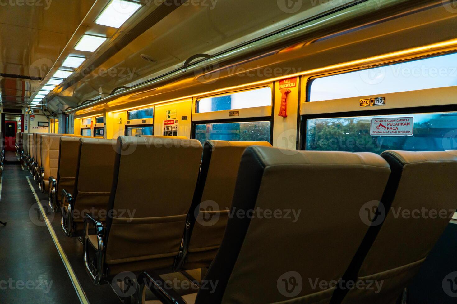 Public trains in Java, Indonesia are empty of passengers in the afternoon when the sun sets. The train carriage was quiet and many passenger seats were empty photo