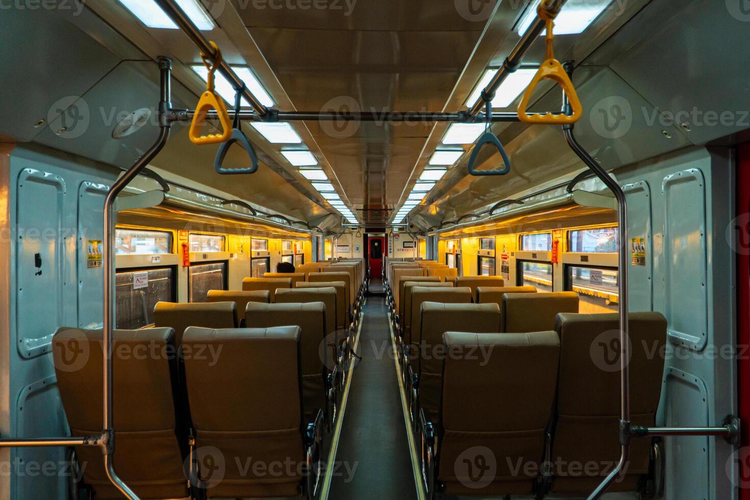 Public trains in Java, Indonesia are empty of passengers in the afternoon when the sun sets. The train carriage was quiet and many passenger seats were empty photo