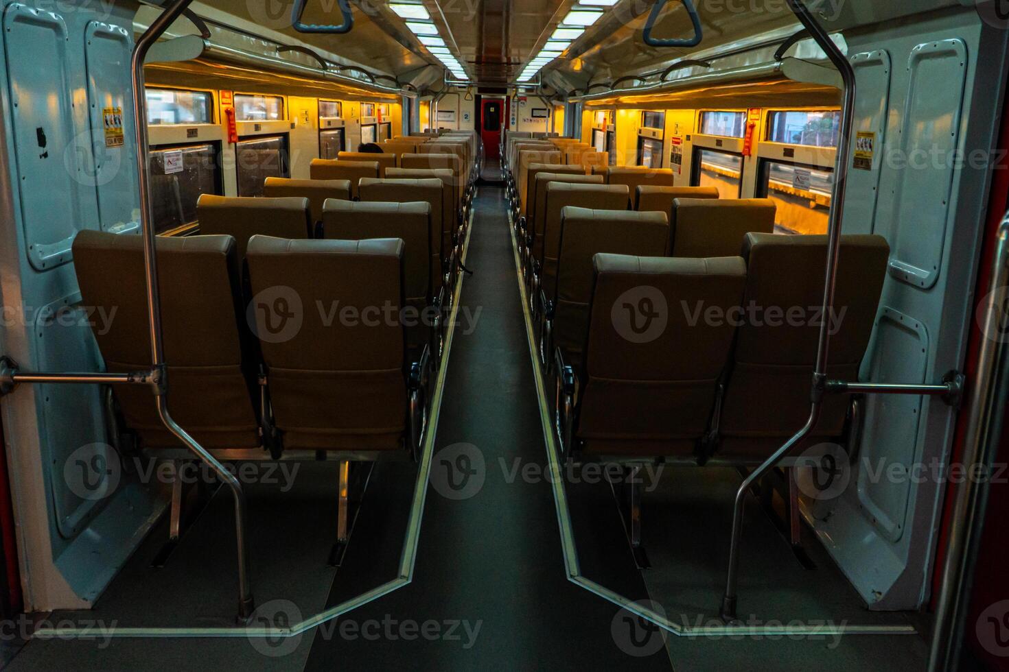 Public trains in Java, Indonesia are empty of passengers in the afternoon when the sun sets. The train carriage was quiet and many passenger seats were empty photo