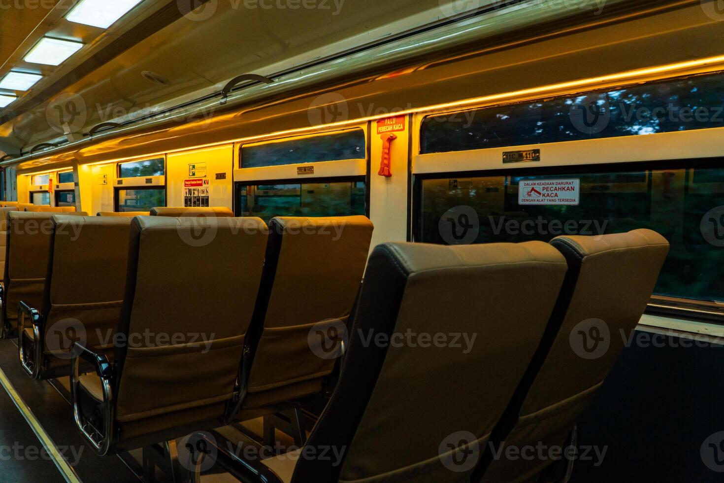 Public trains in Java, Indonesia are empty of passengers in the afternoon when the sun sets. The train carriage was quiet and many passenger seats were empty photo