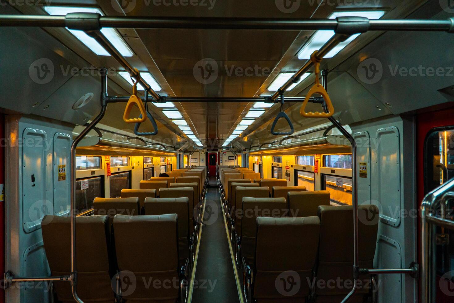 Public trains in Java, Indonesia are empty of passengers in the afternoon when the sun sets. The train carriage was quiet and many passenger seats were empty photo