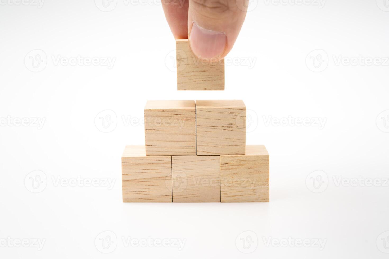 Hand putting and stacking blank wooden cubes on white background with copy space for input wording and infographic icon. photo