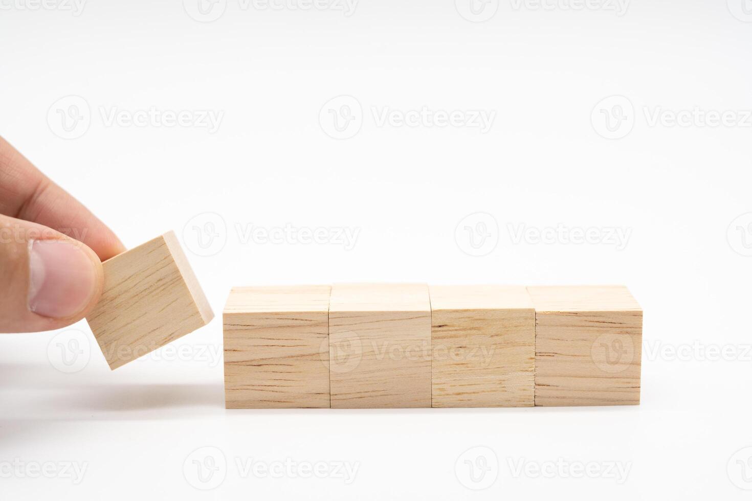 Hand place Blank wooden cube blocks for text isolated on white background. Empty wooden blocks. Copy space. photo