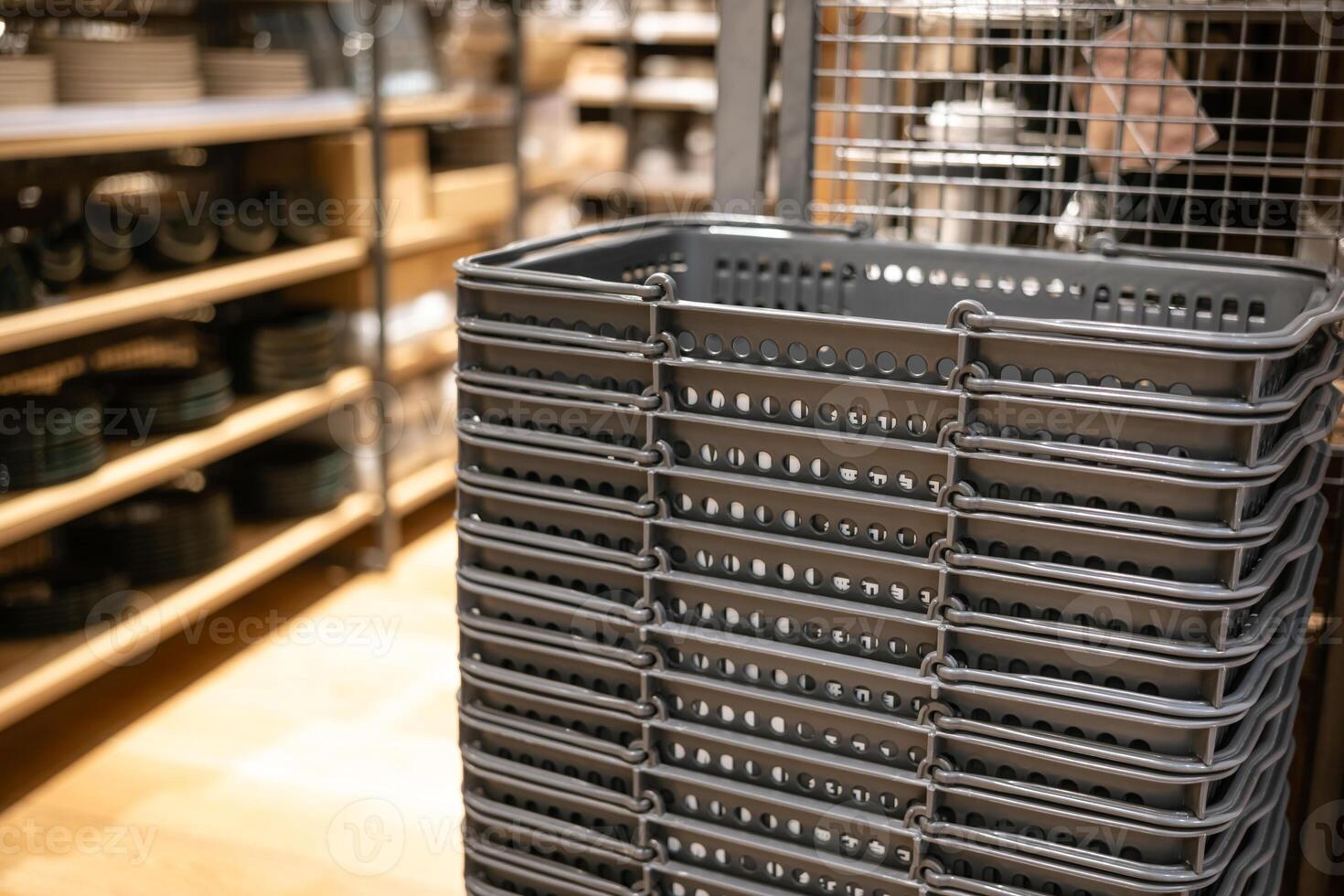 Stack of gray shopping basket in a clothes store. Shopping basket is used to carry the shopping items in a supermarket, mini market, store, or department store. photo