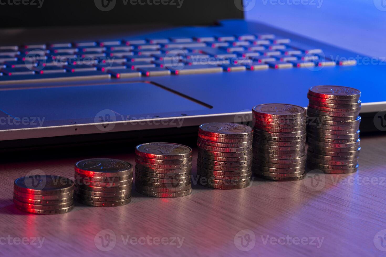 Euro coins on a table with a notebook photo
