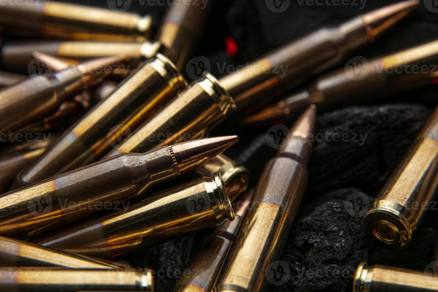 Cartridges for automatic carbine caliber .223 on charcoal. Ammunition for automatic and semi-automatic rifles. Dark back photo