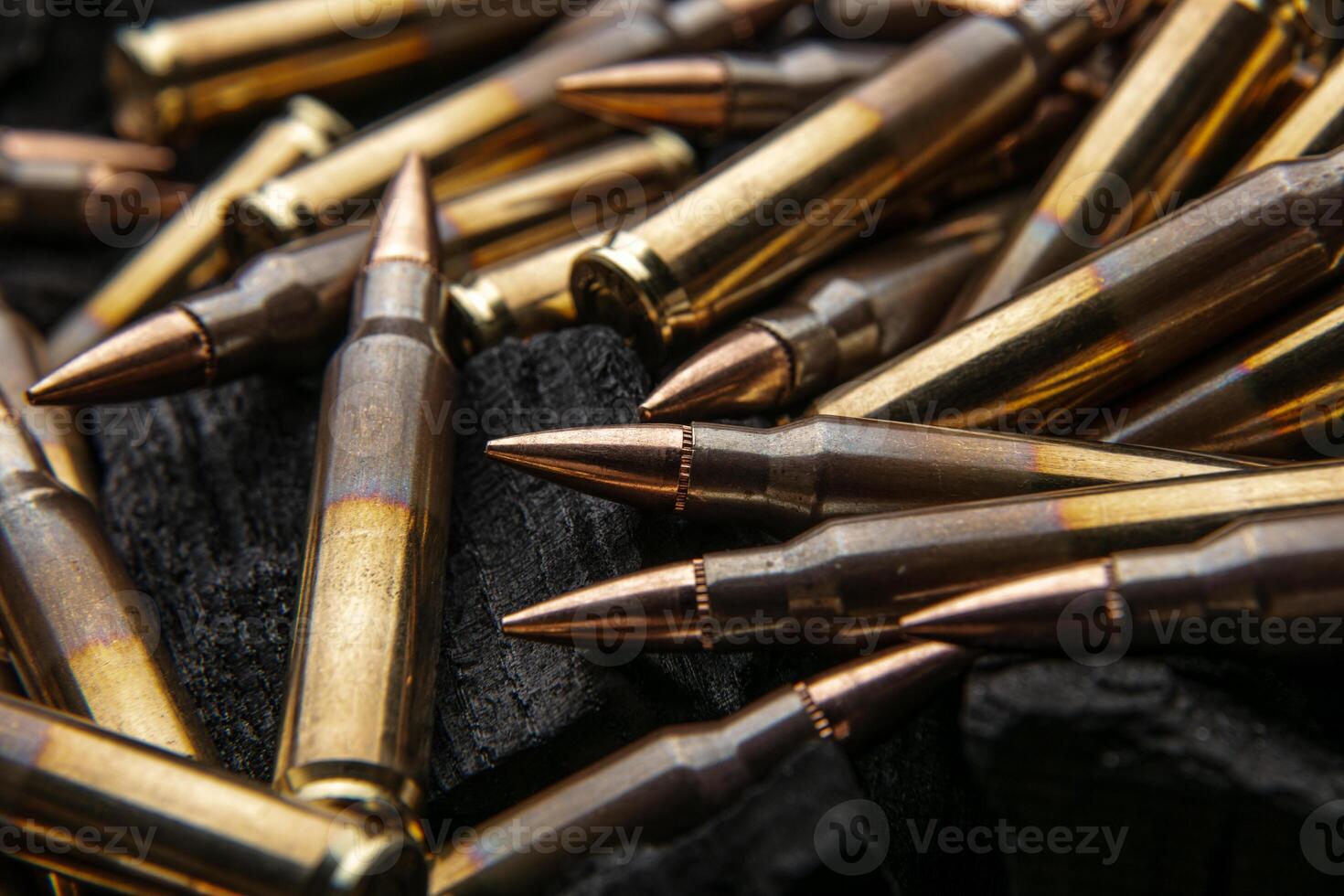 Cartridges for automatic carbine caliber .223 on charcoal. Ammunition for automatic and semi-automatic rifles. Dark back photo