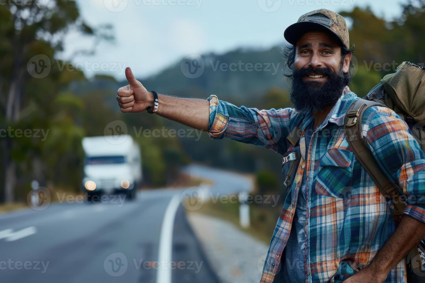 a bearded man with a backpack and a truck is standing on the side of the road photo